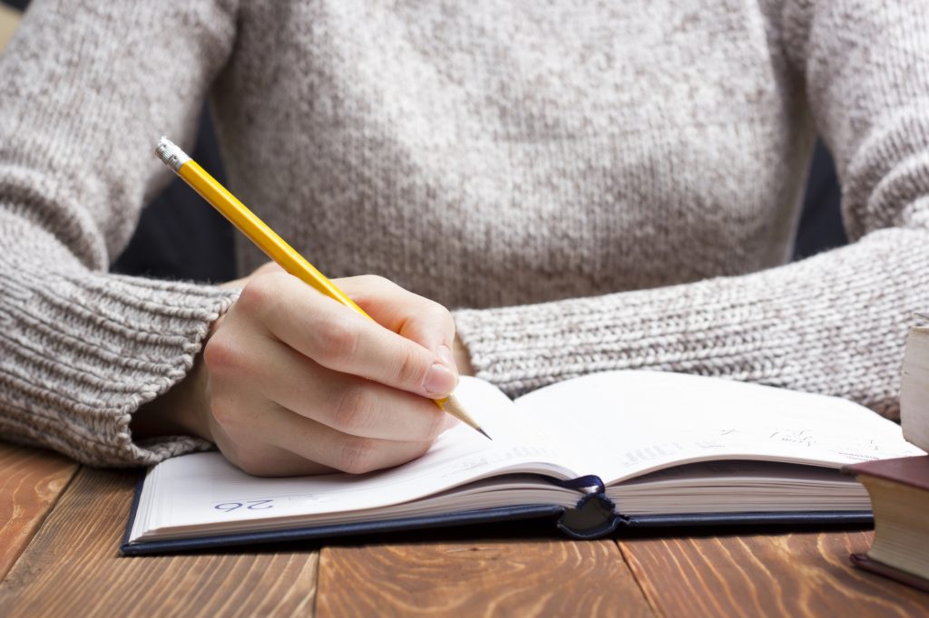 Person writing in journal