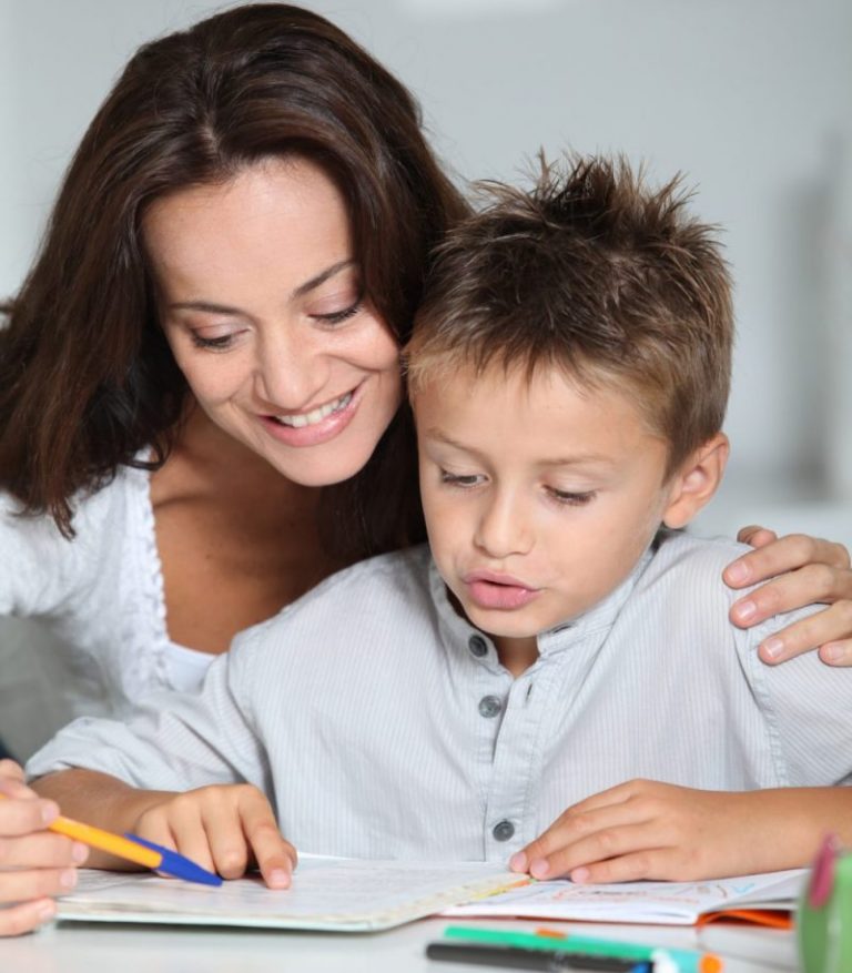 Mother helping child with schoolwork