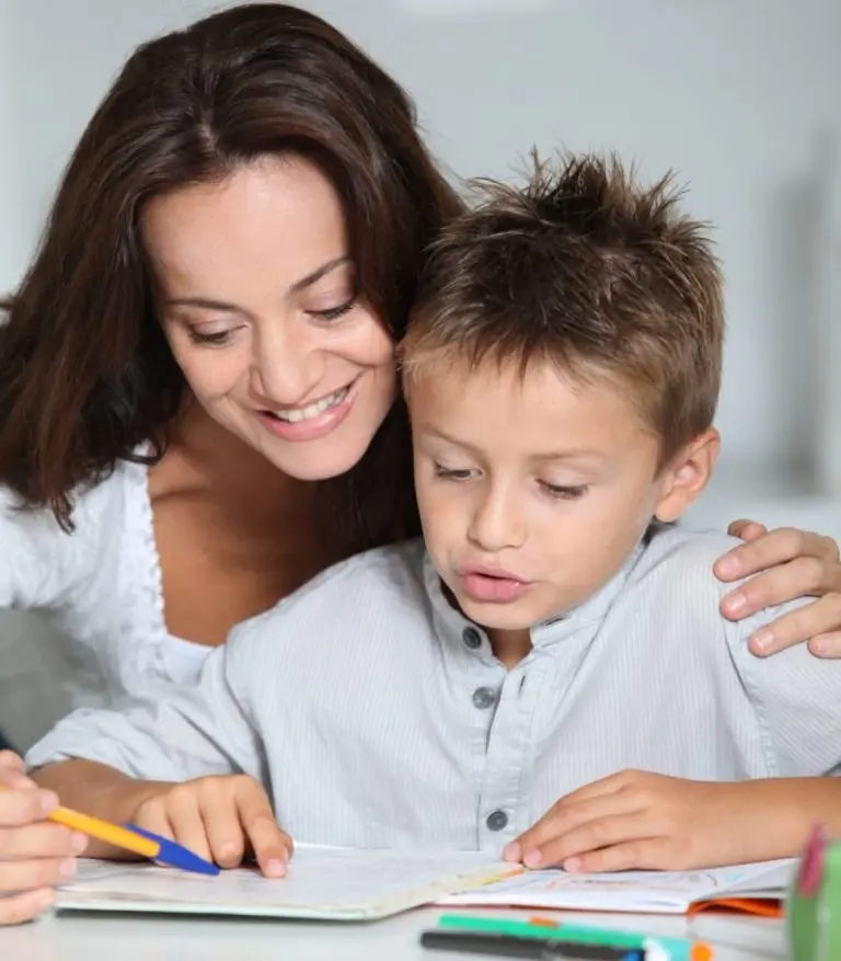 Mother helping child with schoolwork