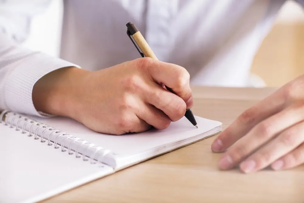 Person journaling, writing by hand