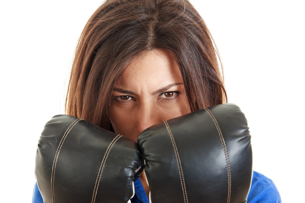 homeschooling mom wearing boxing gloves, in front of her face.